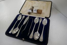 A cased set of five silver teaspoons, a silver small knife and a pair of silver tongs, hallmarked Sh