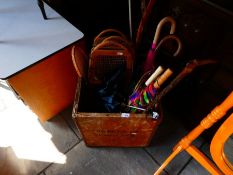 Wooden crate containing umbrellas, walking sticks, rackets, etc