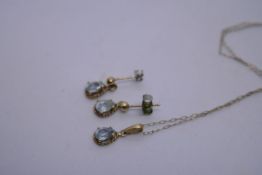 9ct yellow gold fine belcher chain hung with a tear shaped pale sapphire pendant and pair of matchin