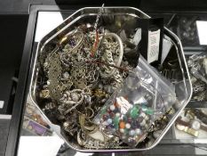 Tin of silver and white metal costume jewellery to include chains, charm bracelets, bangles, etc