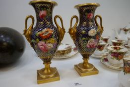 A pair of antique Coalport style vases having floral and gilt decoration with swan handles, height 2