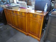 Large breakfront yew wood sideboard with drawers above cupboards