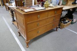 A 1920s oak chest of drawers on cabriole legs 122cm