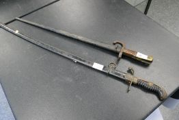 A 19th century French rifle bayonet, etched 1880 with steel scabbard and another sword with steel sc