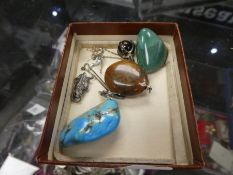 Collection of hardstone pendants including tiger's eye necklace, silver owl charm, etc