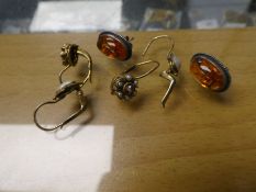 Two pairs of silver gilt earrings and a pair of silver and amber stud earrings