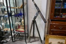 An old military sighting scope by Ross London, on tripod base