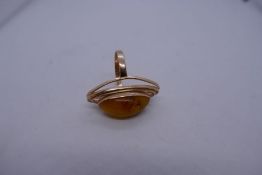 Contemporary 14K Rose gold dress ring with large oval amber coloured stone with gold rings supports,
