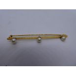 18ct yellow gold bar brooch set with 3 seed pearls, marked 18ct, 6.5cm in fitted tooled leather case