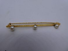 18ct yellow gold bar brooch set with 3 seed pearls, marked 18ct, 6.5cm in fitted tooled leather case