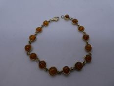9ct yellow gold bracelet set with 15 circular polished amber stones, marked 9ct, 7.9 approx gross, 1