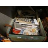 A suitcase and basket containing ephemera  to include newspapers, writing books, clothes patterns po