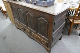 An antique oak mule chest having panelled front with 3 drawers 152cm