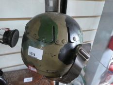 Vintage camouflage helmet and metal headphones