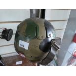 Vintage camouflage helmet and metal headphones