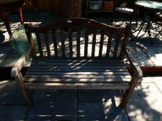 Weathered teak garden bench, with plaque