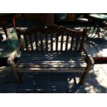 Weathered teak garden bench, with plaque