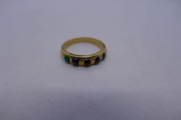 Yellow metal dress ring set with coloured stones