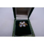 Pretty 9ct dress ring set with 4 oval white opals, and central diamond floral decoration gold should