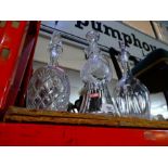 Three lead crystal decanters, one in the form of a Scotch thistle