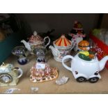A selection of china teapots, glass paperweights and spitfire in a globe