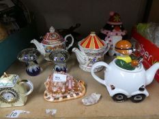 A selection of china teapots, glass paperweights and spitfire in a globe