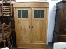 An old stripped pine 2 door wardrobe with green glass panels, 122cm