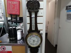 A carved wooden and brass banjo barometer including thermometer