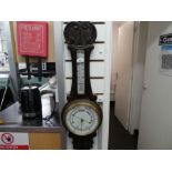 A carved wooden and brass banjo barometer including thermometer