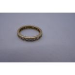 Modern 14K yellow gold clear stone set eternity ring, marked 585, size P, 2.8g approx.