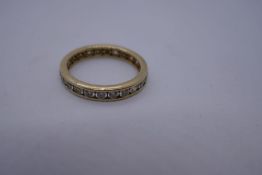 Modern 14K yellow gold clear stone set eternity ring, marked 585, size P, 2.8g approx.