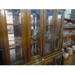 Modern mahogany dresser with glazed doors above cupboards