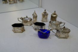 A selection of silver salts, peppers and salt spoons with Bristol blue inserts. With one plate small