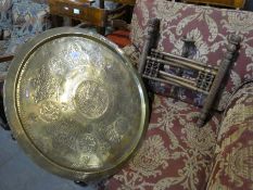 An Eastern brass tray top table on folding base