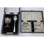 A cased silver egg cup and spoon and with a silver cased spoon and fork. 2.48 ozt approx