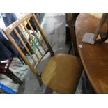 Mid century teak oval extending dining table and set of 4 1970s bar back dining chairs with faux tan