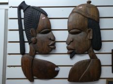 Two carved African tribal plaques of male and female cameo.