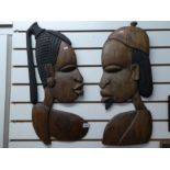 Two carved African tribal plaques of male and female cameo.