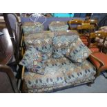 A 1930's walnut bergere suite comprising two seat settee and pair of armchairs