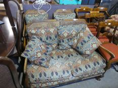 A 1930's walnut bergere suite comprising two seat settee and pair of armchairs