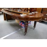 A Victorian mahogany extending dining table, having 2 leaf (1 made of stained pine) extended length