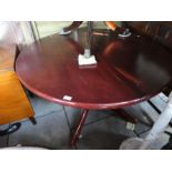 Circular mahogany extending dining table on splayed supports