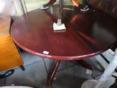 Circular mahogany extending dining table on splayed supports