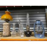 A selection of vintage oil lamps and decanters