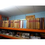 A shelf of leather-bound London-based Pharmacy prescription ledgers, including prescriptions for som