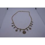 Late 19th Century Pretty yellow metal necklace hung with graduation arrangement of 5 floral pendants