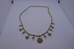 Late 19th Century Pretty yellow metal necklace hung with graduation arrangement of 5 floral pendants