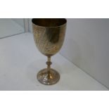 A very nice large trophy cup with engraved, decorative design of a bird, bamboo and palm tree, with