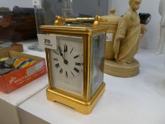 An old brass carriage clock, 8 day with striking movement