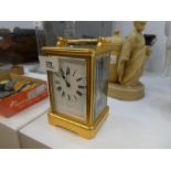 An old brass carriage clock, 8 day with striking movement